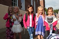 students smile outside of port dickinson elementary school on first day