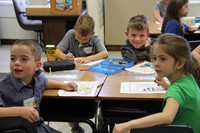 students coloring at table on first day