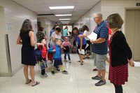 teachers greet students in port dickinson hallway