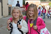 two girl students smile on first day of school