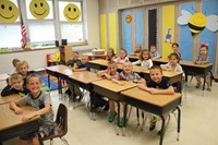 wide shot of classroom of students smiling at port dickinson elementary