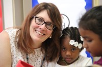 teacher smiles with student