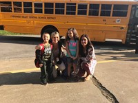 teachers at port dickinson elementary in front of buses with students