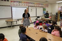 wide shot of first grade teacher teaching students