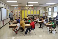 wide shot of teacher teaching a classroom of students