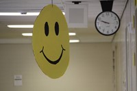 big smiling face sign outside of classroom