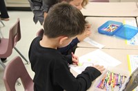 boy coloring on first day of school