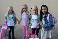 four girl students smile on first day of school