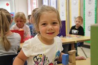 girl smiles sitting in classroom on first day of school