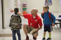 mister novotny helps students on first day of school