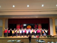 wide shot of students performing on stage