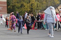 students and teacher parading in halloween costumes