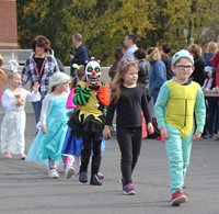 students parading in halloween costumes