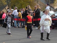 three students wearing halloween costumes