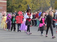 students parading in halloween costumes