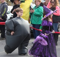 two students walking in halloween costumes