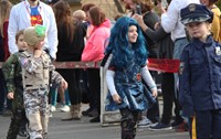 students walking wearing halloween costumes