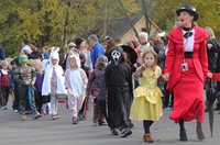 students and teacher parading in halloween costumes