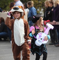 two students wearing halloween costumes