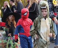 three students wearing costumes