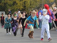 students parading in halloween costumes