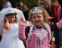 student waving wearing halloween costume