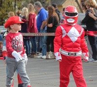 students parading wearing halloween costumes