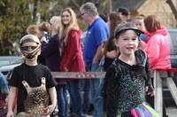 two students walking wearing halloween costumes