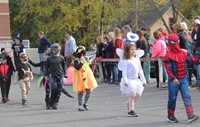 students parading wearing halloween costumes