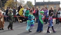 students walking wearing halloween costumes