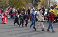 students parading wearing halloween costumes