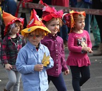 students walking wearing scare crow hats