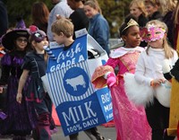 students wearing halloween costumes in parade