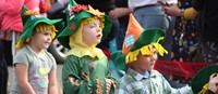 three students wearing scare crow hats