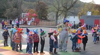 students and teachers parading in scare crow hats