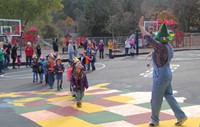 students and teacher wearing scare crow hats in parade