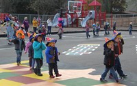 students parading wearing scare crow hats