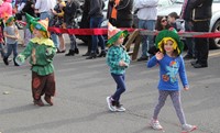 three students parading wearing scare crow hats