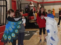 students being mummified at halloween event