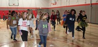 students dancing in gymnasium