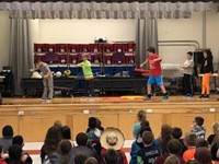 students hula hooping on stage