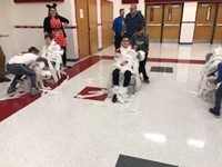 students being mummified with toilet paper