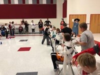 wide shot of students being mummified