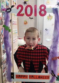 student in costume at photo sign