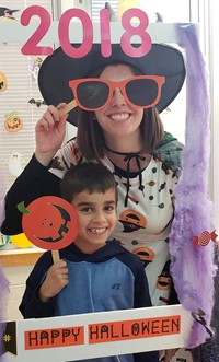 teacher and student in costume with photo sign