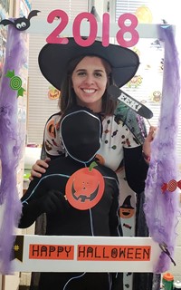 student and teacher wearing costumes at photo booth sign