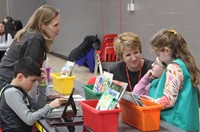 teachers and students at activity station