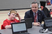 superintendent and student working on lap top computers