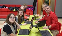 students and teacher at activity station