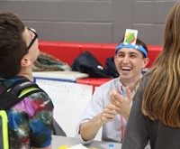 student and teacher laughing during game